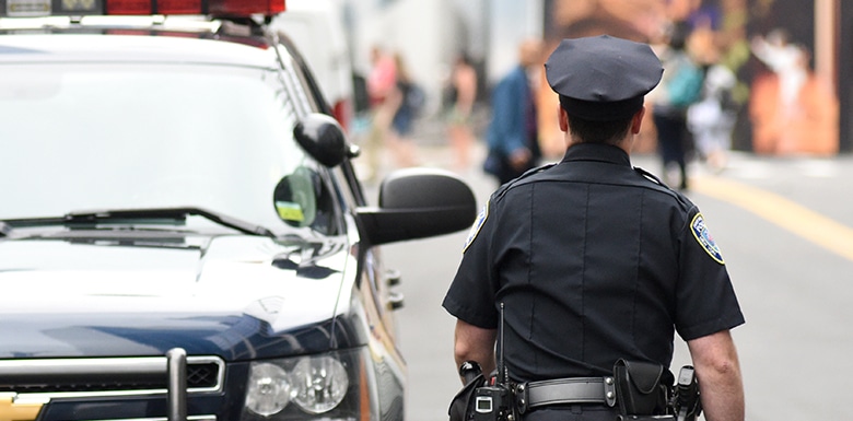 Police officer walking away from his SUV