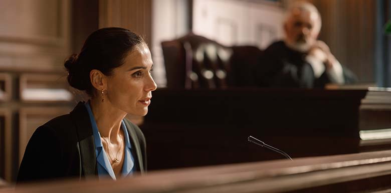 Woman speaking at court next to judge