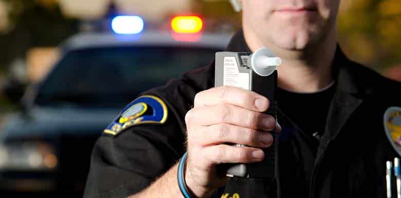 Police officer with breathalyzer