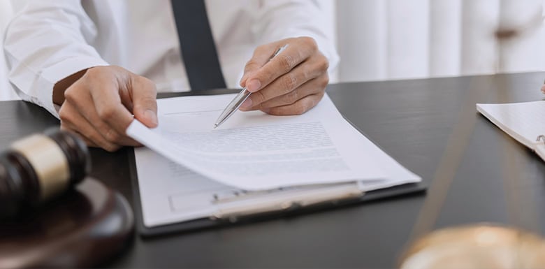 Male attorney sitting at desk reviewing paperwork